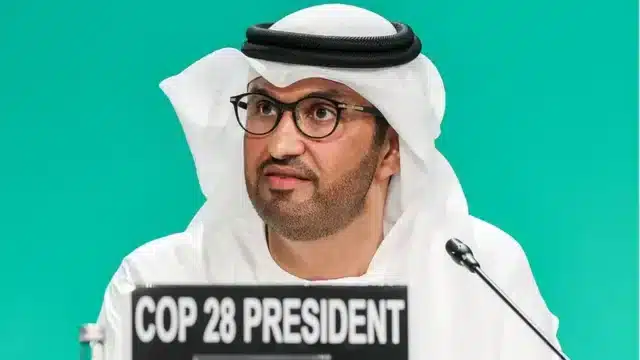 Picture of COP28 President Sultan al-Jaber speaking at the summit.